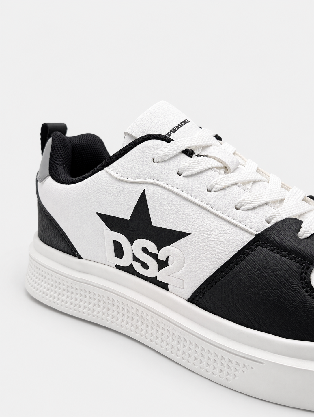 Dettaglio della stella nera con logo DS2 sulle sneakers Platform Star bianco nero